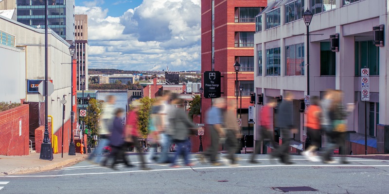 People crossing busy crosswalk out of focus