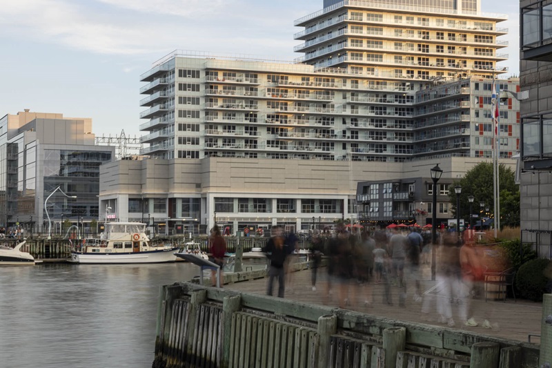 People walking about harbour boardwalk